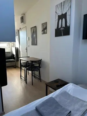 a room with a table and chairs and a bed at Cozy Studio on Metro in Prague