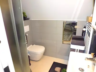 a small bathroom with a sink and a mirror at Cozy Studio on Metro in Prague