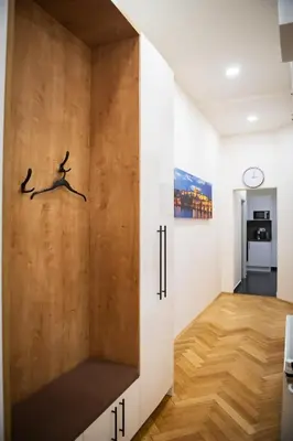 a room with a wooden wall with two birds on it at Apartment Spalená in Prague