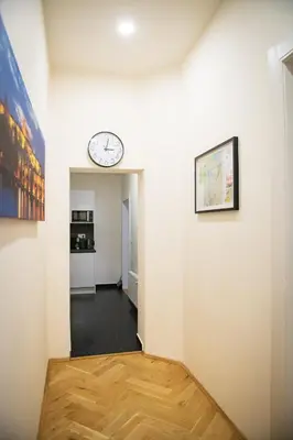 a hallway with a clock on a wall at Apartment Spalená in Prague