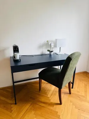 a black desk with a chair and a lamp at Family Villa Hanspaulka in Prague