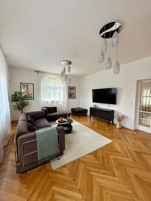 a living room with a couch and a flat screen tv at Family Villa Hanspaulka in Prague