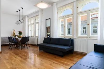 a living room with a couch and a table at Golden Cat Suite in Prague