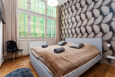 a bedroom with a bed with two pillows on it at Golden Cat Suite in Prague