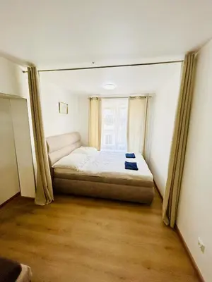 a small bedroom with a bed and a window at A newly renovated Apartment the heart of Prague in Prague