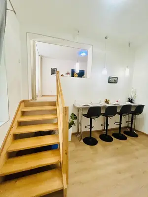 a staircase in a room with a table and chairs at A newly renovated Apartment the heart of Prague in Prague