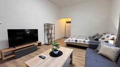 a living room with a couch and a tv at Apartmnet near IP Pavlova in Prague