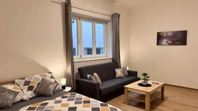 a living room with a couch and a window at Apartmnet near IP Pavlova in Prague