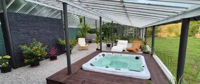 a patio with a hot tub on a deck at Private House with Sauna, Jacuzzi and Hawaiian Hothouse Spa in Velvary