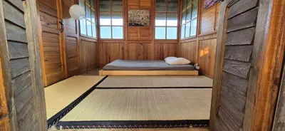 a small room with a bed in a wooden cabin at Private House with Sauna, Jacuzzi and Hawaiian Hothouse Spa in Velvary