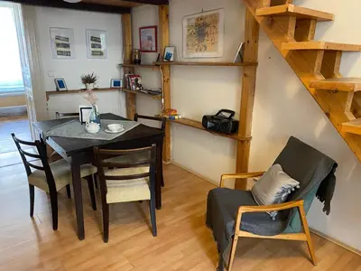 a dining room with a table and chairs at Prague charming flat old Vinohrady in Prague