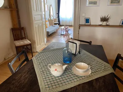 a table with a vase and a tea set on it at Prague charming flat old Vinohrady in Prague