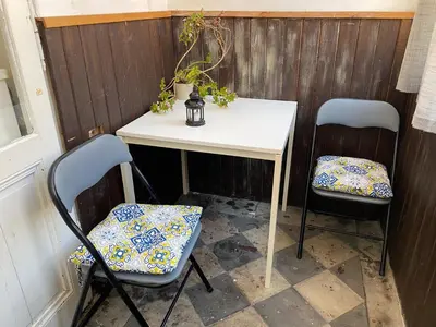 a table with two chairs and a table with a table and two at Prague charming flat old Vinohrady in Prague