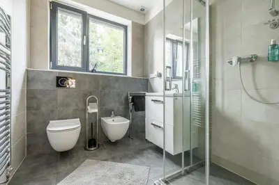 a bathroom with a toilet and a sink and a shower at Airport Prague Luxury Apartment & Spa in Prague