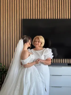 a bride and her mother standing next to a piano at Airport Prague Luxury Apartment & Spa in Prague