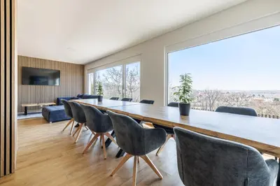 a large dining room with a long table and chairs at Airport Prague Luxury Apartment & Spa in Prague