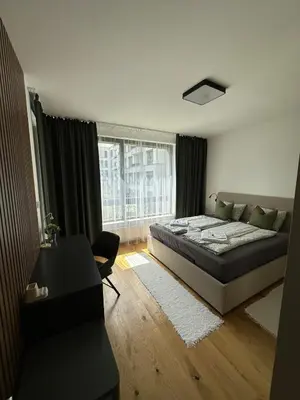 a bedroom with a bed and a large window at Prague's Bohemian Grey in Prague
