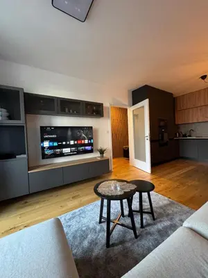 a living room with a couch and a table at Prague's Bohemian Grey in Prague