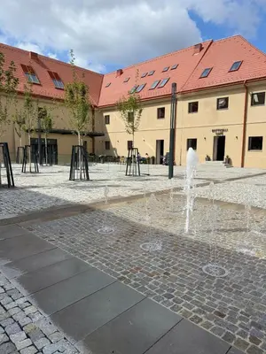 a fountain in a courtyard in front of a building at Prague's Bohemian Grey in Prague