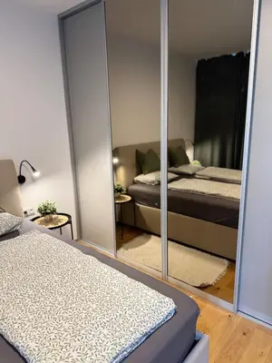 a bedroom with two beds and a mirror at Prague's Bohemian Grey in Prague