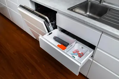 an open drawer in a kitchen next to a sink at Home for Successful Businessman in Prague