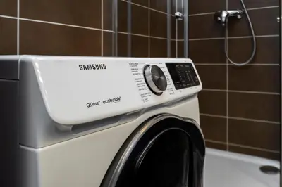a washer and dryer in a bathroom at Home for Successful Businessman in Prague