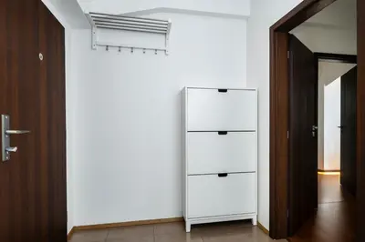 a white cabinet in a room with a hallway at Home for Successful Businessman in Prague