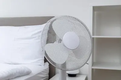 a white fan sitting next to a bed at Home for Successful Businessman in Prague
