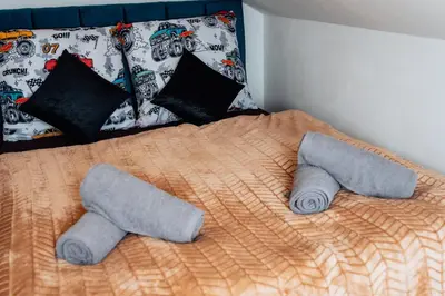 a bed with two pillows and two towels on it at Royal Elephant Residence in Prague