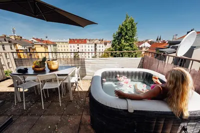 a little girl laying in a tub on a patio at Royal Elephant Residence in Prague