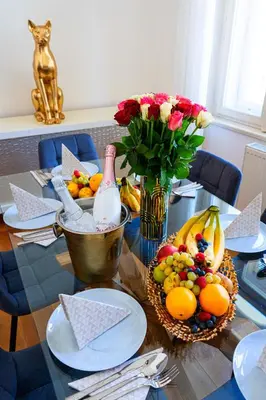 a dining room table with fruit and a vase of flowers at Big Cat Residence in Prague