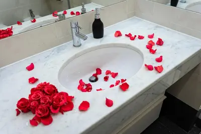 a bathroom sink with red roses on a counter at Big Cat Residence in Prague