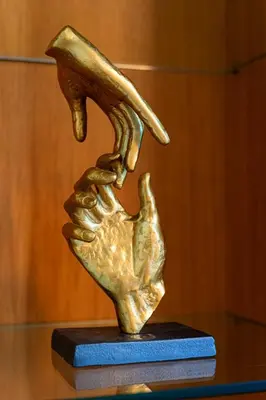 a bronze statue of a hand on a table at Big Cat Residence in Prague