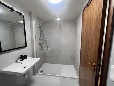 a white bathroom with a sink and a shower at Apartment with Terrace in Prague in Prague