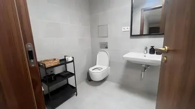 a white bathroom with a toilet and a sink at Apartment with Terrace in Prague in Prague
