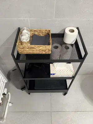 a shelf with a basket and toilet paper on it at Apartment with Terrace in Prague in Prague