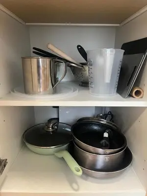 a shelf with cooking utensils and a pot and pans at Apartment with Terrace in Prague in Prague