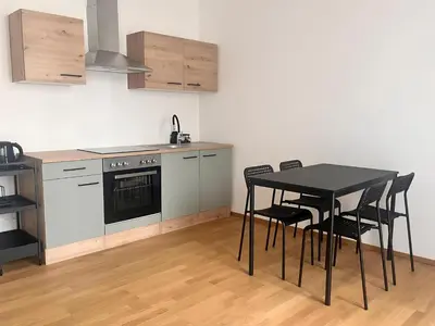 a kitchen with a black table and black chairs at Apartment with Terrace in Prague in Prague
