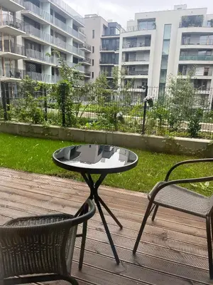 a table and a chair on a patio with buildings at Apartment with Terrace in Prague in Prague