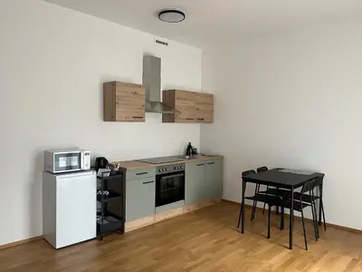 a kitchen with a stove and a microwave and a table at Apartment with Terrace in Prague in Prague