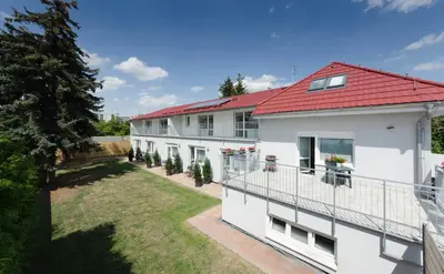 an aerial view of a white building with a red roof at Pension Zličín in Prague