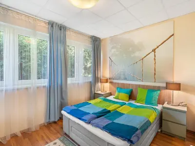 a bedroom with a bed with a colorful comforter at Apartment U Rybníka by Interhome in Stříbrná Skalice