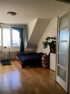 a bedroom with a bed and a large window at Bright and calm flat in Prague