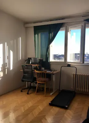 an office with desks and chairs and a large window at Bright and calm flat in Prague