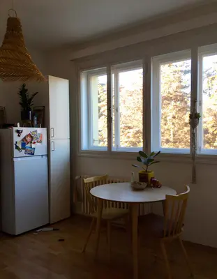 a kitchen with a table and a white refrigerator at Bright and calm flat in Prague