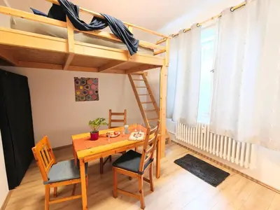 a dining room with a table and a bunk bed at Comfy place in Prague