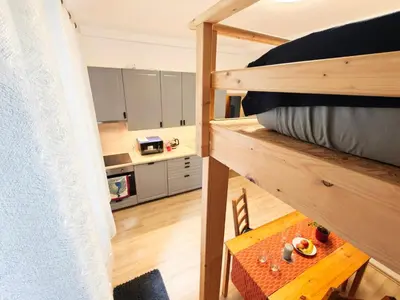 a room with a bunk bed and a table at Comfy place in Prague