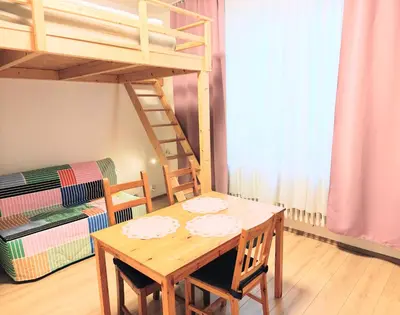 a dining room with a table and a bunk bed at Comfy place in Prague