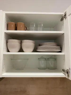 a cabinet filled with bowls and plates and dishes at Sokolska apartment in Prague