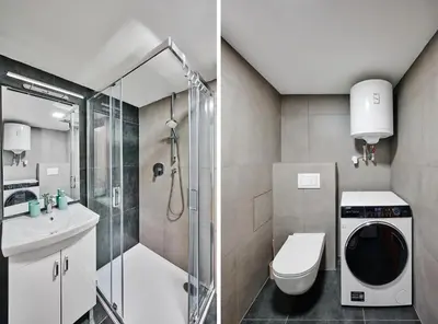 a bathroom with a shower toilet and a washing machine at Sokolska apartment in Prague